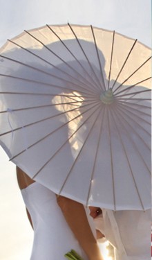 beach wedding kiss silhouette with umbrella