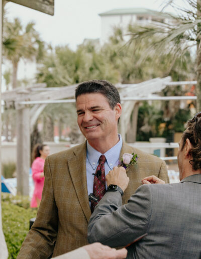 An image of me pinning a boutonnière as the event coordinator
